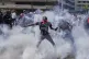 Protesters scatter as police fire teargas at them during a demonstration in downtown Nairobi, Kenya, June 25, 2025