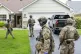 Armed FBI agents search for an active shooter, sweeping a neighborhood adjacent to the home of Minnesota DFL State Representative Melissa Hortman, in Brooklyn Park, Minn., June 14, 2025