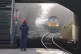 A passenger waits for a train at Denton railway station in Greater Manchester