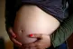 A pregnant woman holding her stomach in London