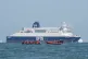A boat intercepts people thought to be migrants on board a RIB (rigid inflatable boat) as it passes by the DFDS ferry Dover Seaways in the English Channel off the coast of Calais, France, July 4, 2025