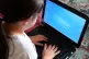 A child using a laptop computer