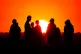 A crowd of people watching the setting sun from a hill in Ealing, west London