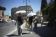 People use umbrellas in hot weather to shelter from the sun while walking past the Colosseum, in Rome, Monday, June 30, 2025