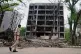 A policeman walks past buildings damaged in the June 12 Air India plane crash in Ahmedabad, India, July 12, 2025