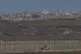 An Israeli army vehicle moves along the border of the Gaza strip, as seen from a southern Israel location, July 13, 2025