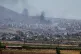 Smoke rise from clashes between Syrian government forces and Druze militias in Sweida city, southern Syria, July 15, 2025