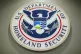 The Department of Homeland Security logo is seen during a news conference in Washington, February 25, 2015