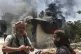 Bedouin fighters stand in front a burned shop at Mazraa village on the outskirts of Sweida city, during clashes between the Bedouin clans and Druze militias, southern Syria, July 18, 2025