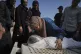 Relatives of Palestinian child Salem Hussein, 12, killed in an Israeli army bombardment of Gaza, mourn beside his body at Shifa Hospital in Gaza City, July 22, 2025