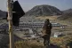 A Taliban fighter stands on a hill overlooking a camp housing refugees who have been repatriated from Pakistan, near the Pakistan-Afghanistan border, in Torkham, Afghanistan, May 31, 2025