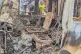 People gather around the charred remains of a burned vehicle following a deadly attack in Komanda, Ituri province of eastern Congo, July 27, 2025