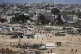 Palestinians rush to collect humanitarian aid airdropped into Zawaida in central Gaza Strip, July 31, 2025