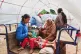 A Cambodian family sits on a tractor cart of as they return home from a temporary shelter in Prasat Roboeuk village, Oddar Meanchey province, Cambodia, July 29, 2025