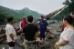 In this photo released by Xinhua News Agency, rescuers talk to villagers on a road damaged by floodwaters in Miyun District as continuous rain fall triggers alerts, in north of Beijing on July 27, 2025. Photo: Ju Huanzong/Xinhua via AP