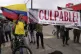 Opponents of former President Alvaro Uribe display a sign reading in Spanish 