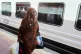 A Sudanese woman, who was driven from her home and is now returning, prepares to enter her train to Aswan at Cairo's Ramses railway station, Egypt, July 21, 2025