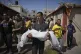 A relative carries the body of Palestinian girl Mira Bashir, 10, who was killed with her sister, Sabah, 8, in an Israeli army airstrike of the Gaza Strip, during their funeral in Deir al-Balah, July 2, 2025