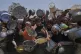 Palestinians struggle to get donated food at a community kitchen, in Gaza City, northern Gaza Strip, July 26, 2025