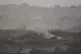 An Israeli army tank advances in the Gaza Strip, as seen from southern Israel, July 3, 2025
