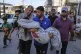 Relatives carry the body of 13-year-old Seraje Ebrahim, killed in an Israeli strike on a drinking water distribution point, for burial outside Al-Awda Hospital in Nuseirat, central Gaza Strip, July 13, 2025