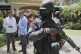 Security guards stand watch as Haiti's Prime Minister Alix Didier Fils-Aime (centre) talks with the Mexico's Charge d'Affaires Jesus Cisneros after attending an event marking one year since the start of the Multinational Security Support Mission in Port-au-Prince, Haiti, June 26, 2025