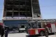 Firefighters gather in front of a burning hypermarket building in Kut, Iraq, July 17, 2025