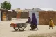 A woman and young girl displaced from Boko Haram attacks push a cart in Dikwa, Borno province, north east Nigeria, April 29, 2025