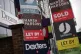 Various For Sale, Sold and Let By estate agent signs juxtaposed next to a Dreams store in Clapham, London