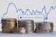 Money is stacked in front of the London Stock Exchange website displaying the FTSE 100 index. Picture date: Monday February 3, 2025