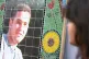 Vivian Figueiredo (right), cousin of Jean Charles de Menezes, looks across at a mosaic of Jean outside Stockwell Tube station in south London where he was shot dead by police, July 22, 2009