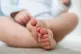 A baby plays with toys at home in Northamptonshire
