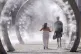 A couple cool off as they walk through a cooling water feature spraying a fine mist in Dover, Kent, July 11, 2025
