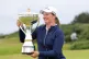 England's Lottie Woad holds the trophy after winning the 2025 ISPS HANDA Women's Scottish Open on day four at the Dundonald Links, Irvine, July 27, 2025