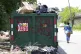 A woman walks past a garbage collection site, July 9, 2025, in Philadelphia