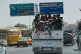 Armed Bedouin fighters ride in the back of a pickup truck as they return from the southern province of Sweida to Damascus, Syria, July 19, 2025
