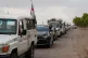 Syrian Bedouin families ride in a convoy led by Red Crescent vehicles in Busra al-Harir, heading to Daraa after being evacuated from Sweida following more than a week of violent clashes, July 21, 2025