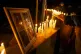 A person lights a candle during a vigil in front of El Teniente copper mine, operated by Codelco, where a cave-in killed one worker and trapped five others underground, halting operations in Rancagua, Chile, August 2, 2025