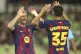 Barcelona's Robert Lewandowski, left, celebrates with his teammate Gerard Martin after scoring a goal during a friendly soccer match between FC Barcelona and Daegu FC at the Daegu Stadium in Daegu, South Korea, Monday, Aug. 4, 2025