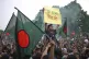 Students and locals shout slogans as they gather to commemorate 