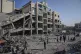 People inspect the damage at the Sheikh Radwan al-Taba UNRWA clinic following an Israeli army bombardment in Gaza City, August 6, 2025