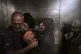 Raed Salem Aslyieh (left) from Jabaliya, hugs his relatives after the death of his son, Ahmed Raed Aslyieh (18), who succumbed to injuries sustained in an Israeli strike that killed eight other family members four months earlier, Gaza City, August 6, 2025