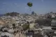 Palestinians rush to collect humanitarian aid airdropped by parachutes into Gaza City, northern Gaza Strip, August 7, 2025