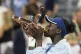 Victoria Mboko of Canada kisses the trophy following her win over Naomi Osaka of Japan during finals tennis action at the National Bank Open in Montreal, August 7, 2025. Photo: Christinne Muschi/The Canadian Press via AP