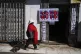 A woman walks past a campaign center for supporters of former President Evo Morales who are in favor or a null vote in the upcoming presidential election in El Alto, Bolivia, Tuesday, Aug. 12, 2025