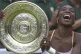 Venus Williams laughs as she holds the Women's Singles trophy on the Centre Court at Wimbledon Saturday, July 8, 2000