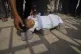 The body of five-year-old Jamal al-Najjar is placed on the ground atop bricks before a funeral prayer after he died at Nasser Hospital in Khan Younis, southern Gaza Strip, August 12, 2025. The head of Nasser's pediatrics unit said Jamal, who was born with rickets, died from severe malnutrition