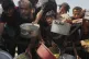 Palestinians struggle to get donated food at a community kitchen in Gaza City, northern Gaza Strip, August 16, 2025