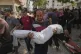 A Palestinian man carries the body of his seven-year-old nephew, Alaa al-Toum, who was killed by an Israeli army air strike the night before, during his funeral at Shifa Hospital in Gaza City, August 16, 2025