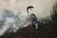 A man battles a wildfire in Veiga das Meas, northwestern Spain, Saturday, Aug. 16, 2025